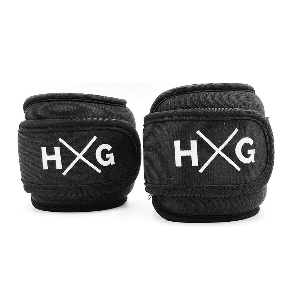 Dos pesas negras para muñeca o tobillo con logo HXG blanco sobre fondo blanco.