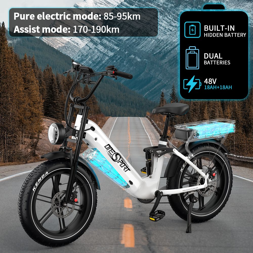 Una bicicleta eléctrica blanca con neumáticos anchos en una carretera.