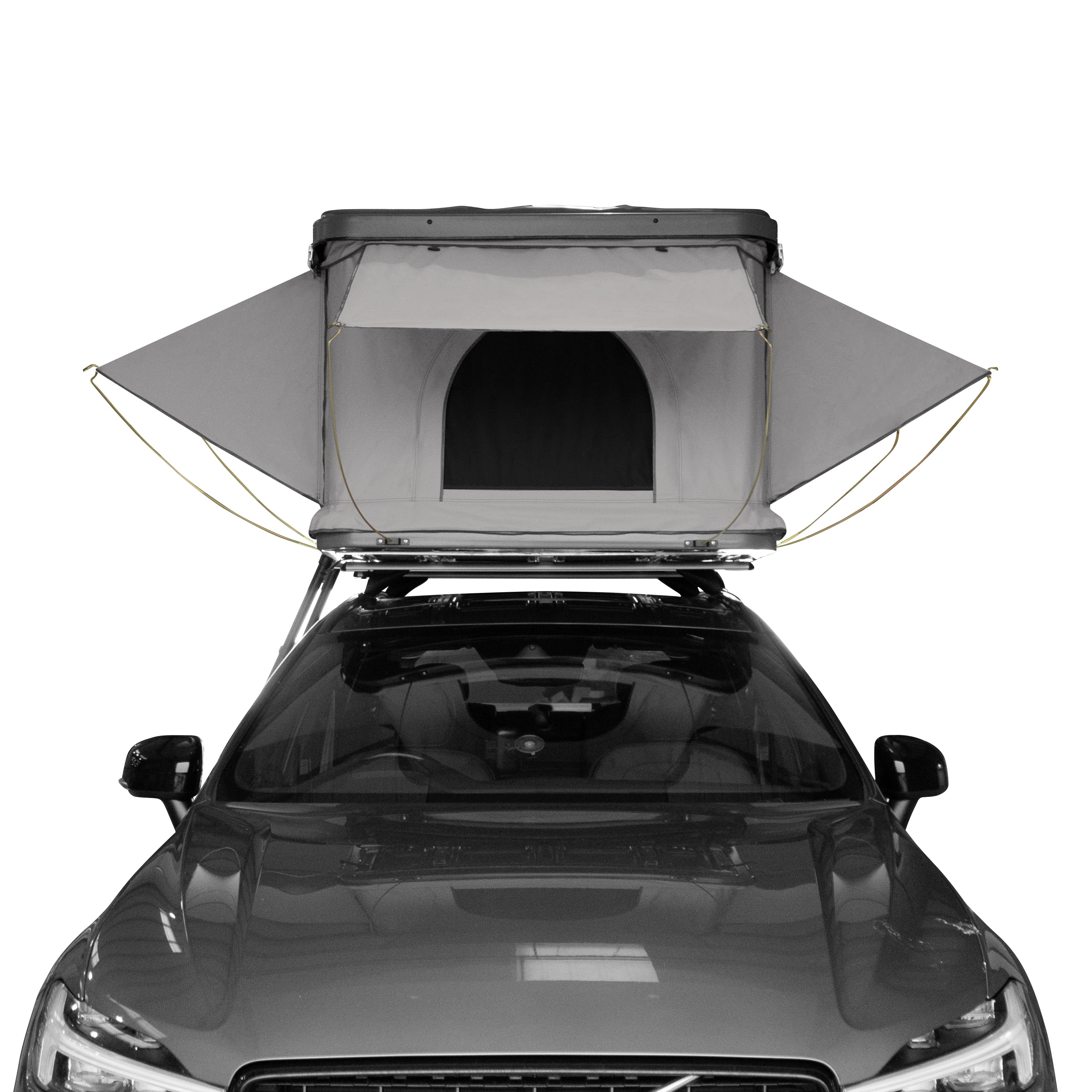 Una tienda de techo gris está montada en un coche oscuro.