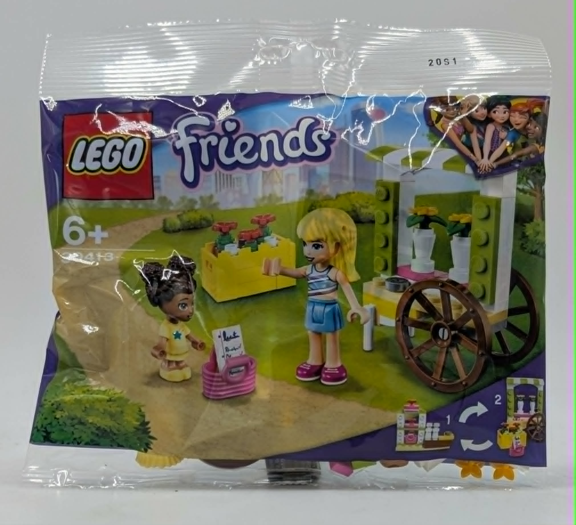 Giocattolo LEGO Friends con due figure, un carretto di fiori e un'aiuola.