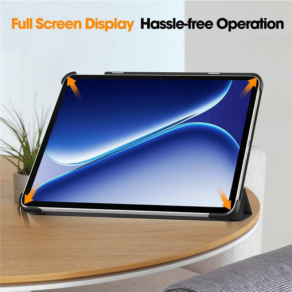 Black tablet case with orange arrows pointing to corners on a wooden table.