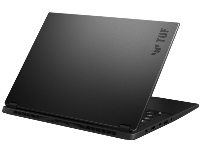 Siyah ASUS TUF dizüstü bilgisayar, kapak açık, kapakta TUF logosu ve yanda portlar görünüyor.