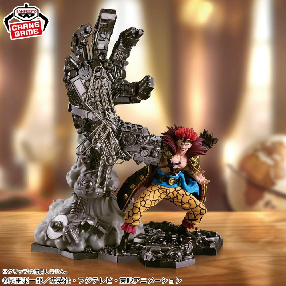 Figur eines Mannes mit roten Haaren neben einer mechanischen Hand mit Büroklammern.