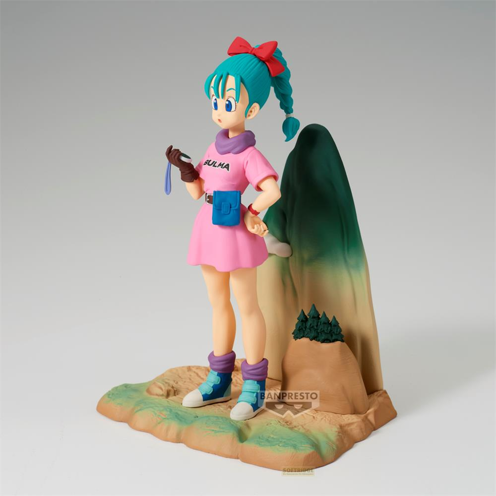 Figura di Bulma con vestito rosa e stivali blu su base rocciosa, vicino a una montagna.