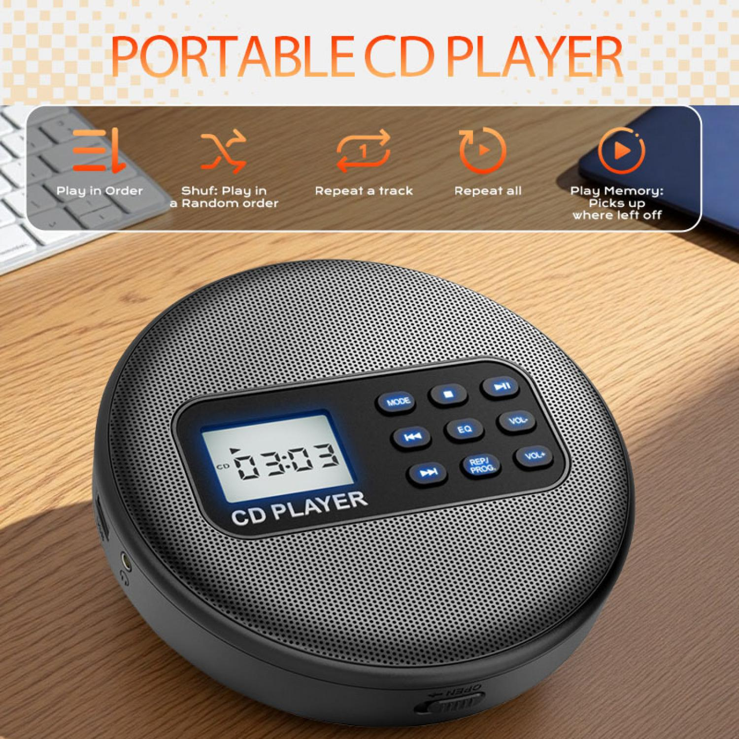 Tragbarer CD-Player mit Display und Tasten auf einem Holztisch.