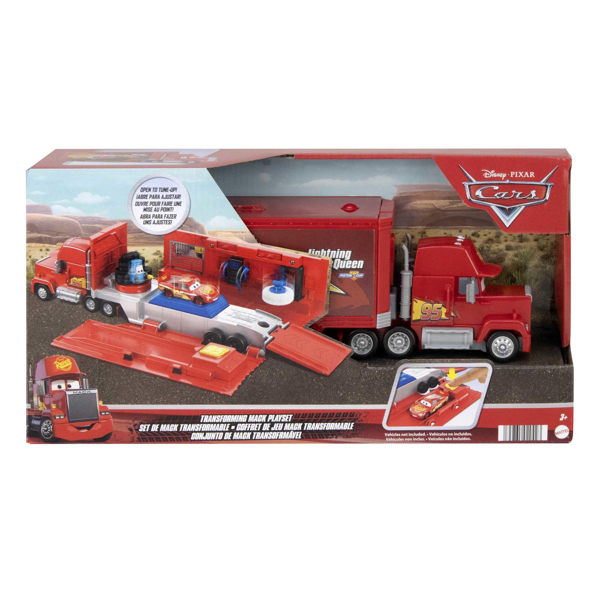A red toy Mack truck hauler opens to reveal a workshop with Lightning McQueen.