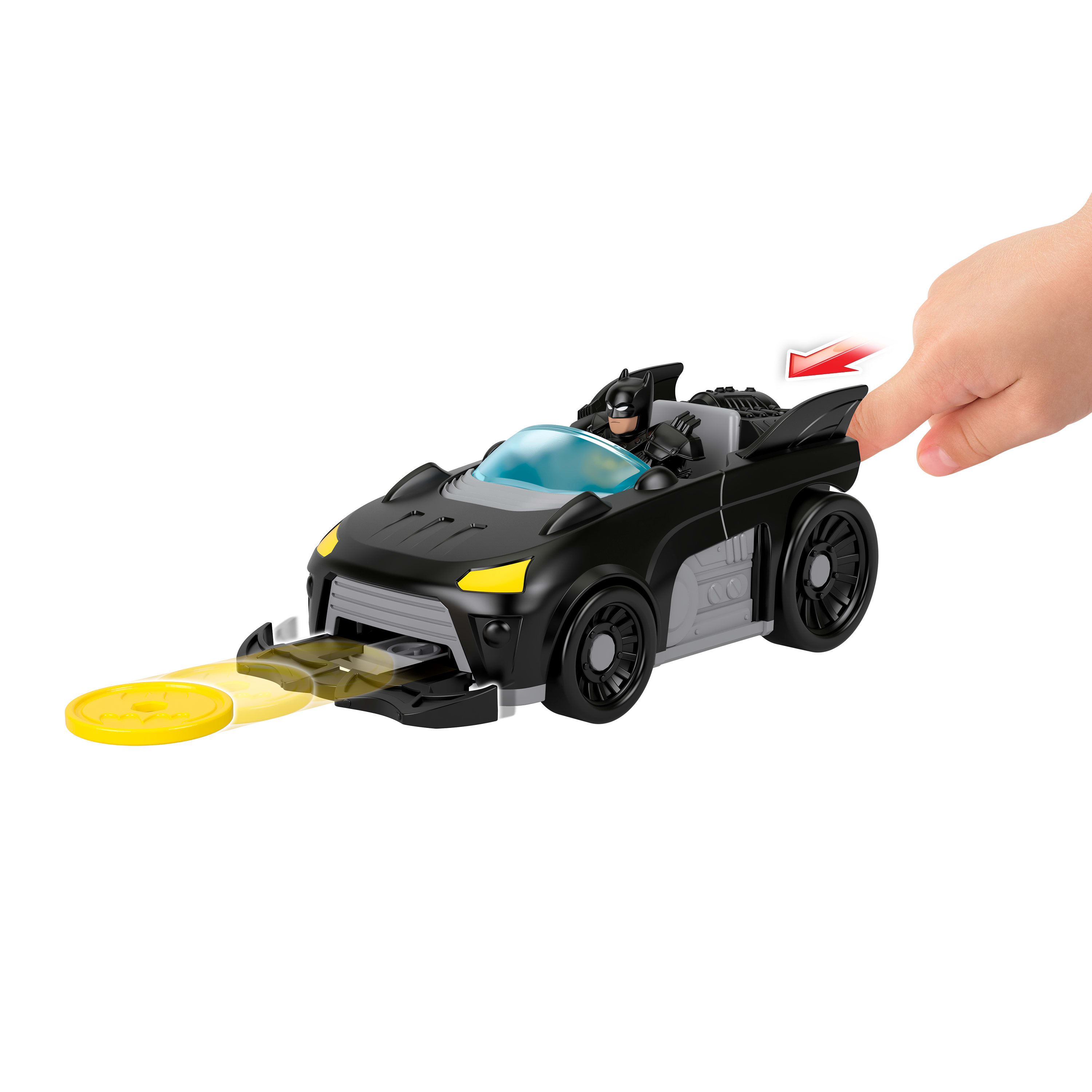 Un Batmóvil de juguete negro con figura de Batman y un disco amarillo.
