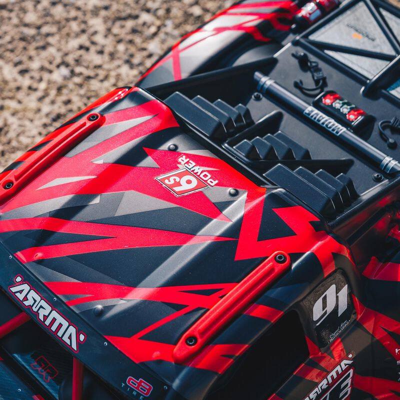 Une voiture télécommandée rouge et noire avec un autocollant "6S POWER".