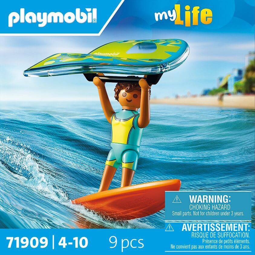 Una figura de Playmobil con un traje de neopreno amarillo y azul surfea en una tabla naranja, sosteniendo una tabla de surf verde y azul.