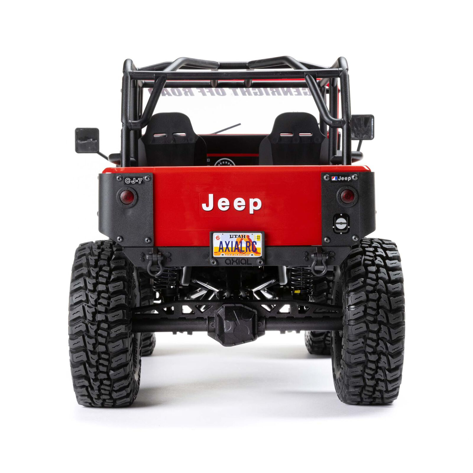 Jeep CJ-7 rosso con roll bar, sedili neri e pneumatici grandi.