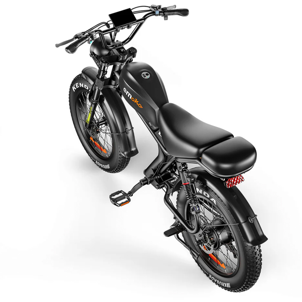 Bicicleta eléctrica negra con neumáticos anchos, suspensión y pantalla digital.