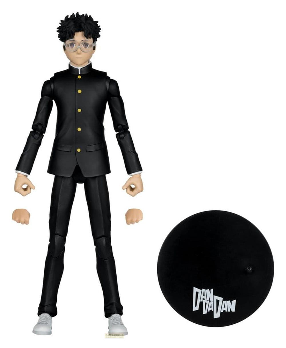 Actionfigur eines Jungen im schwarzen Anzug mit Brille, neben einer schwarzen Basis.