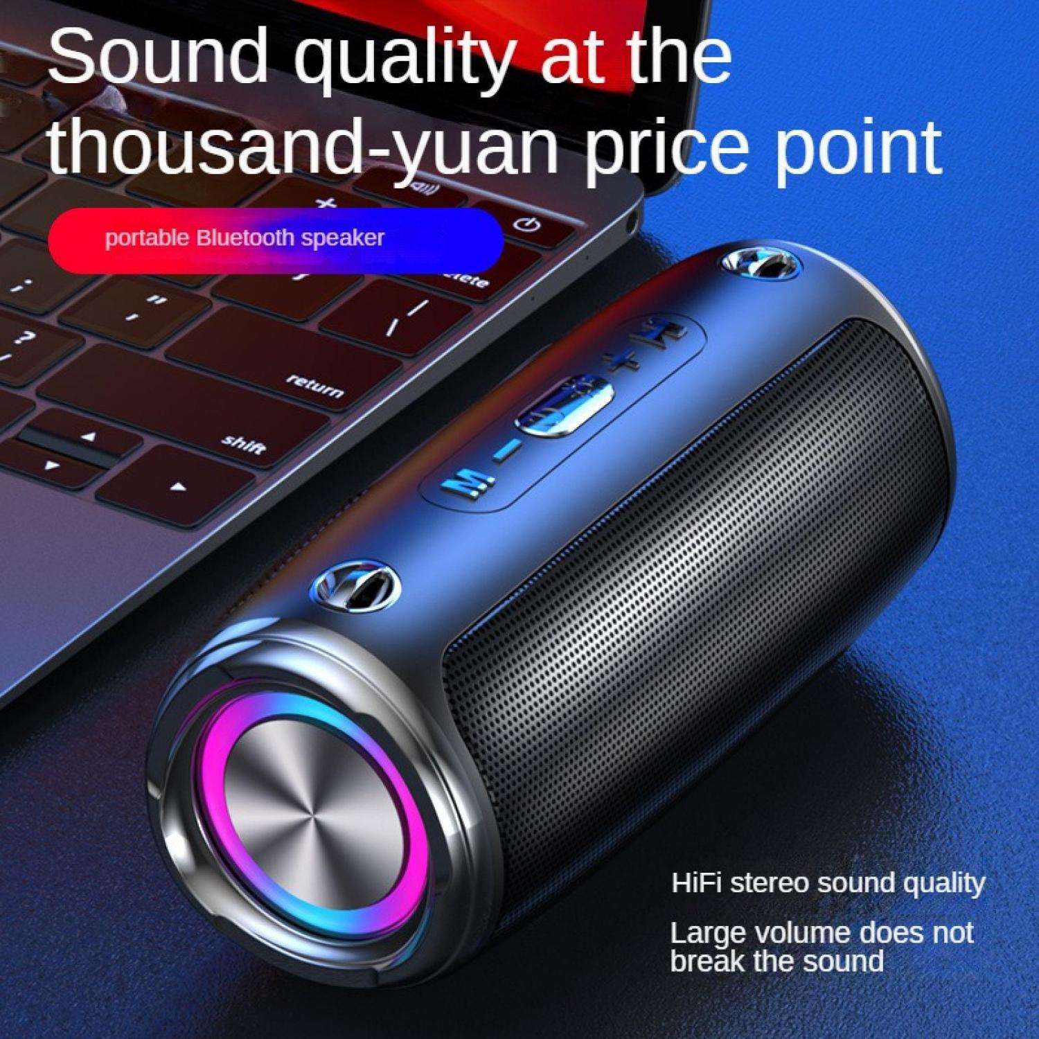 Ein tragbarer Bluetooth-Lautsprecher mit beleuchtetem Ring neben einem Laptop.