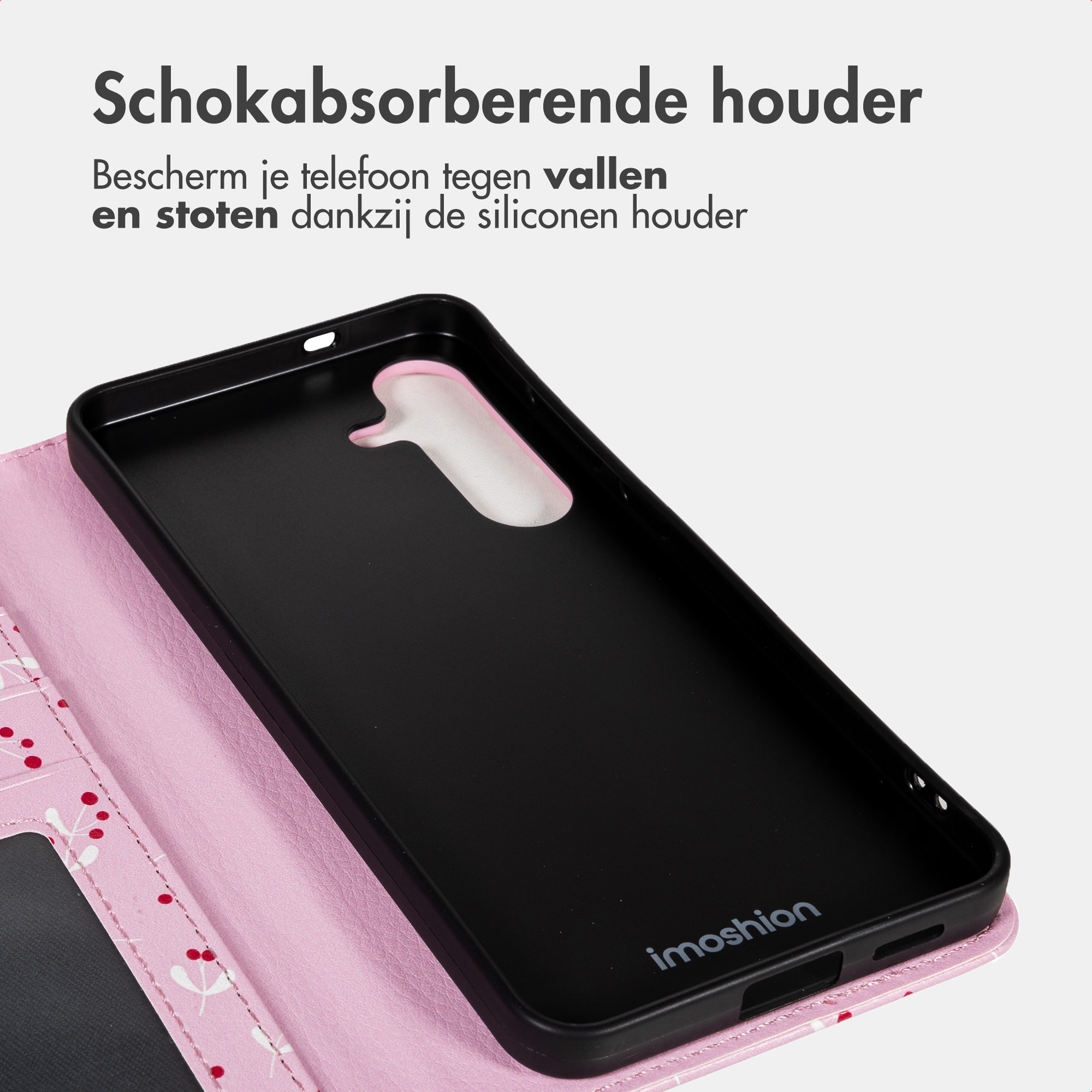 Una custodia nera per telefono con interno rosa è aperta, rivelando uno slot per schede su una copertina a fantasia rosa e bianca.