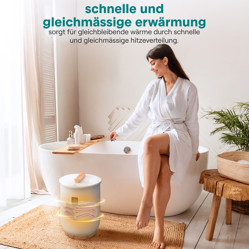 Frau im Bademantel sitzt neben einem Heizgerät für Handtücher.