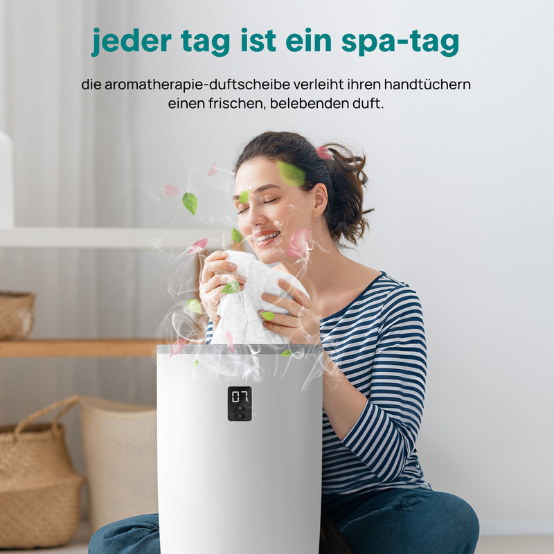 Eine Frau riecht an einem Handtuch, das aus einem Diffusor kommt.