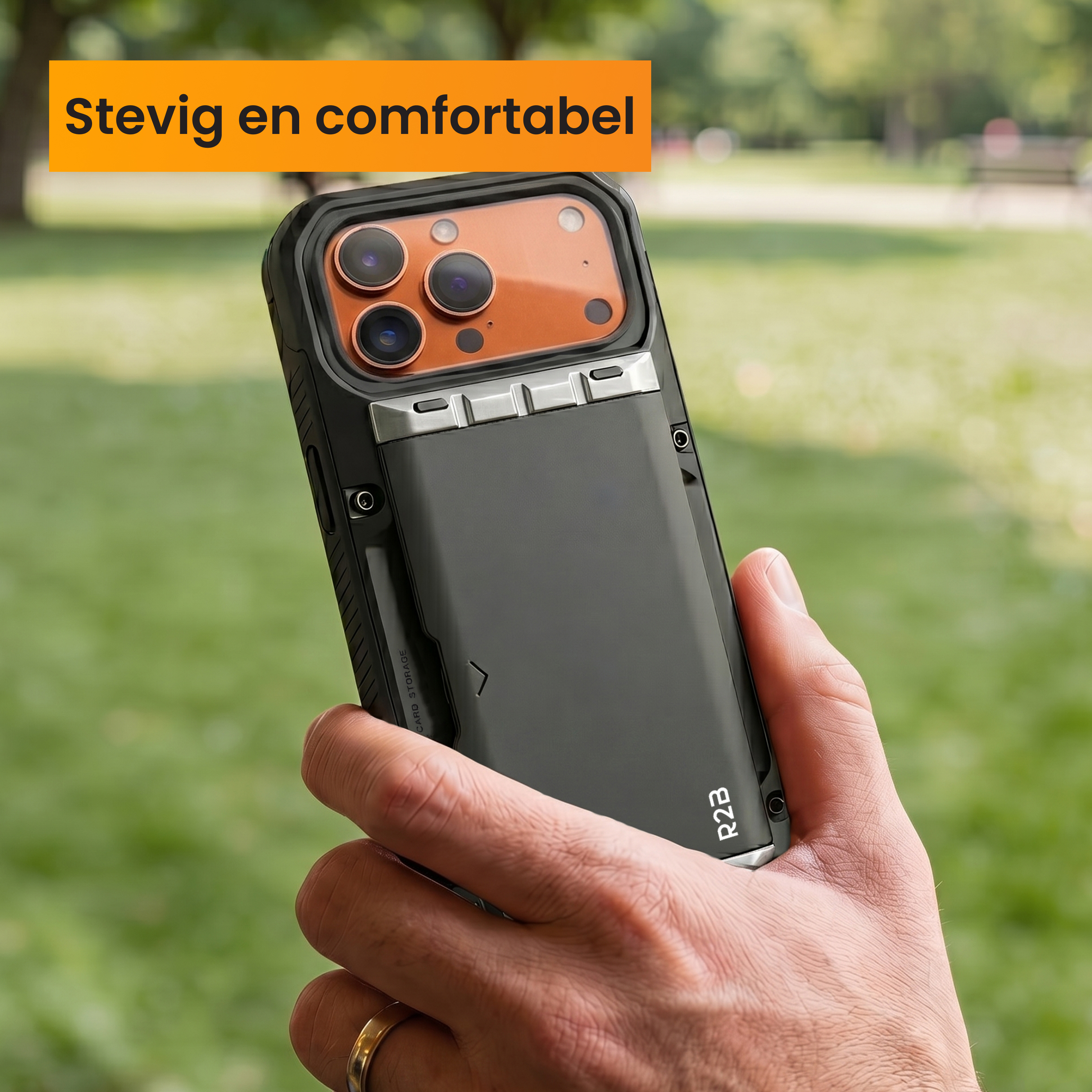 A hand holds a black phone with card holder against a green background.