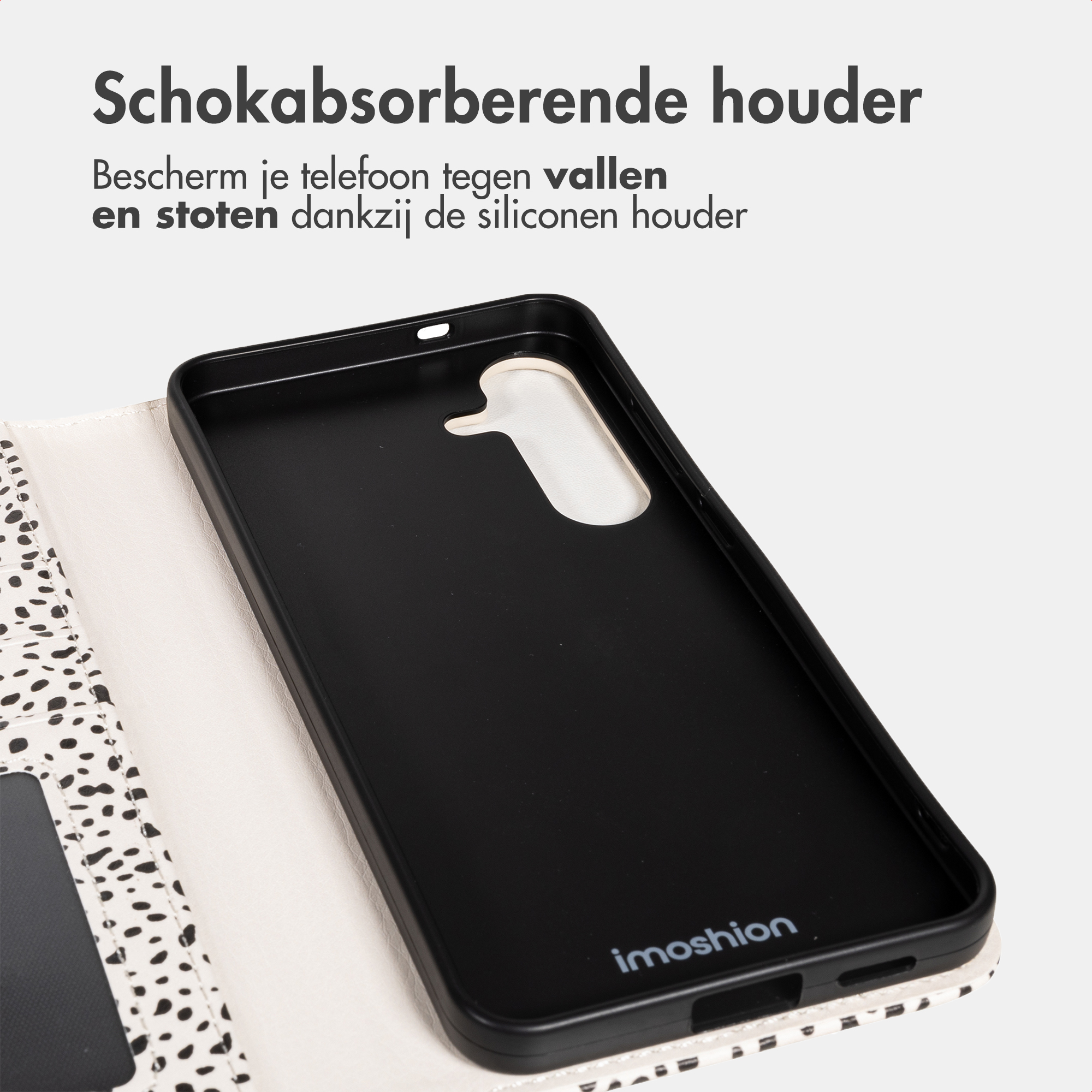 Black phone case with white dalmatian spot detail on the interior flap.