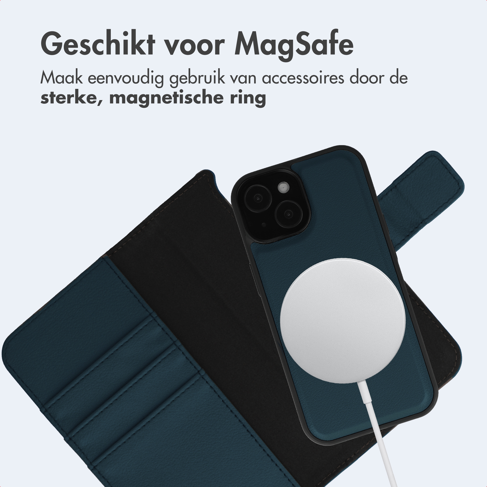A phone in a dark blue case with a white MagSafe charger attached, next to an open wallet case.