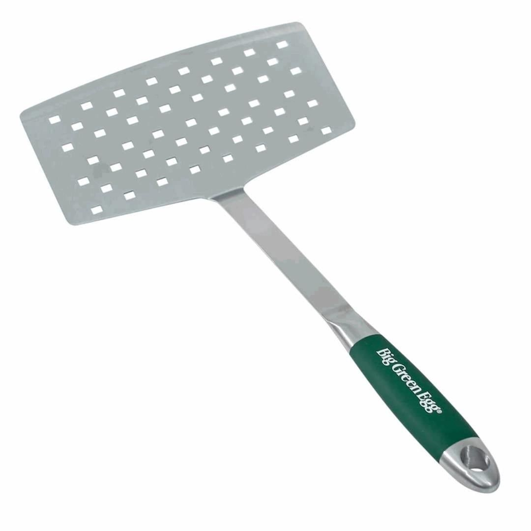 Gümüş ızgara spatulası, dikdörtgen delikli başlık ve yeşil saplı.