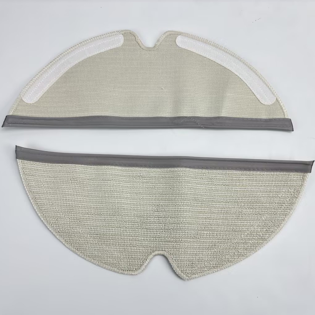 Two round, beige mop pads with grey edges and velcro fasteners.