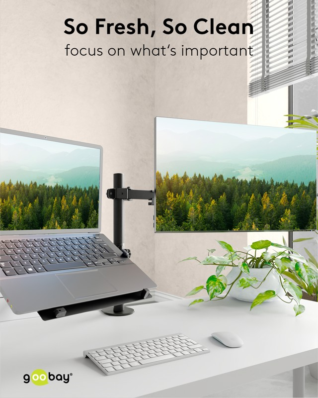 Una scrivania pulita con un laptop e un monitor su un supporto, tastiera, mouse e una pianta in vaso. Testo: "So Fresh, So Clean"