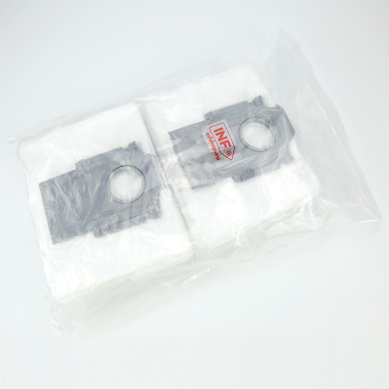 Two white vacuum cleaner bags with gray holders inside a plastic bag.