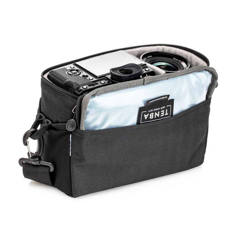 A black camera bag with a camera system inside.