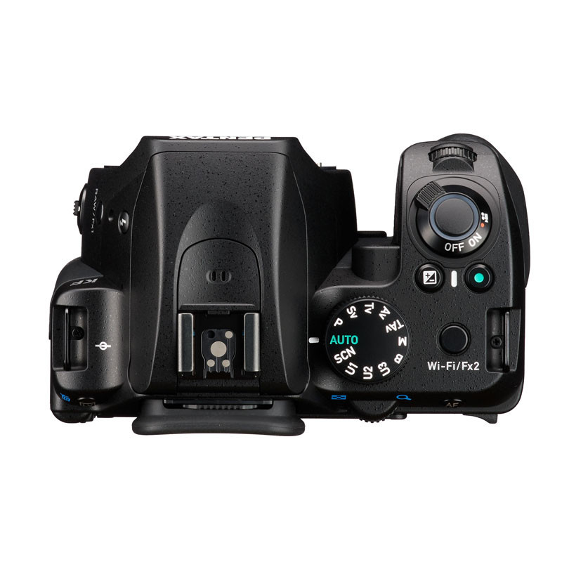 Bovenaanzicht van een zwarte digitale camera, met keuzewiel en knoppen.