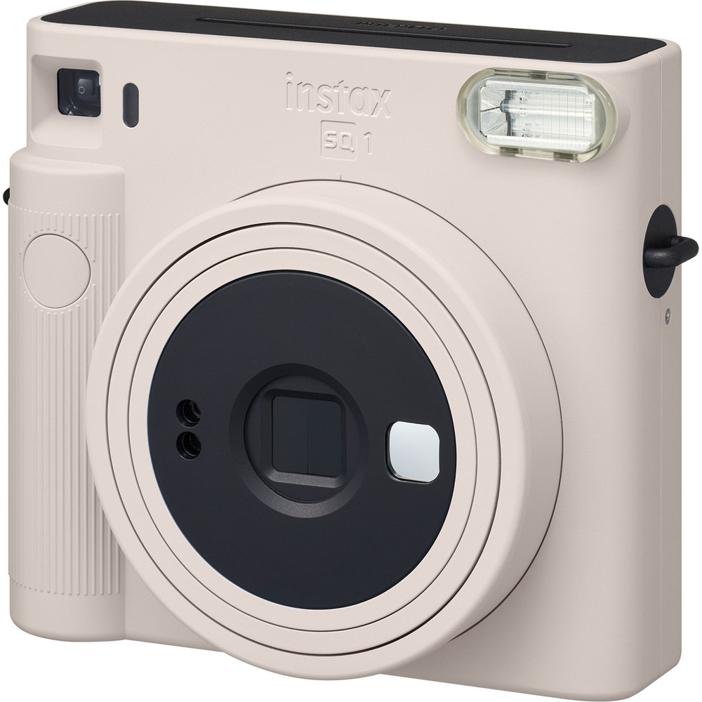Siyah lensli ve flaşlı açık krem rengi anında fotoğraf makinesi.