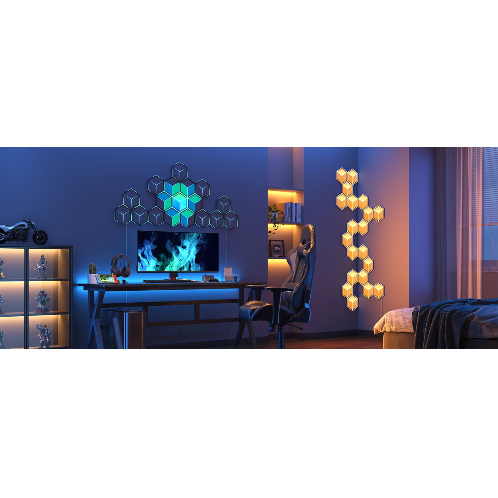 Une installation de jeu avec bureau, chaise, moniteur et lumières murales géométriques bleues et vertes.