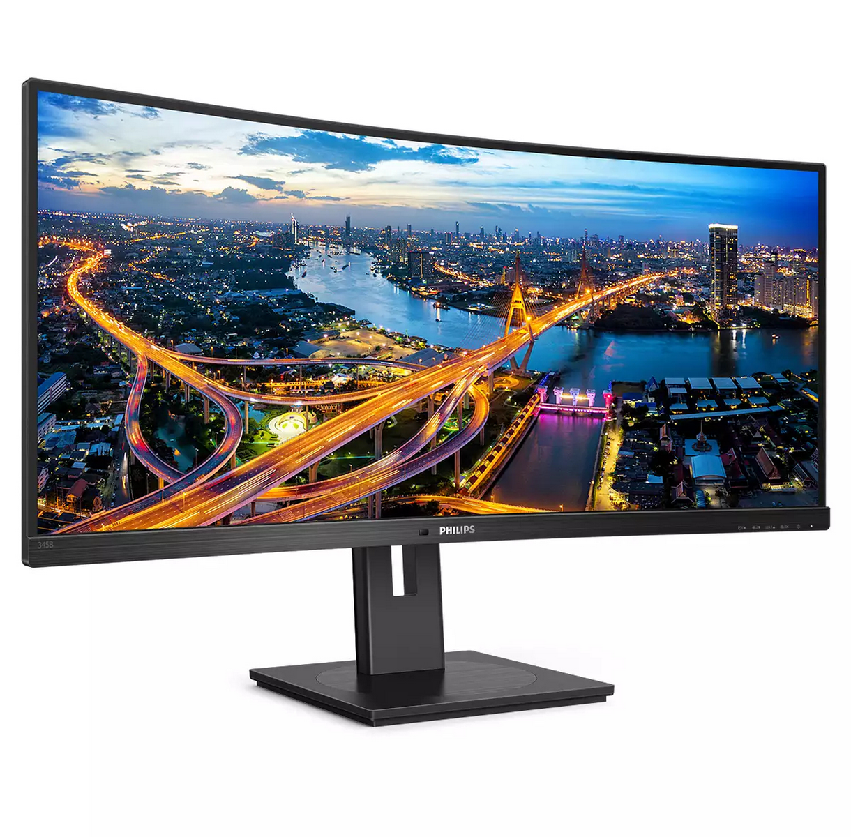 Monitor curvo Philips mostrando un vibrante horizonte nocturno de ciudad con río y autopistas iluminadas.