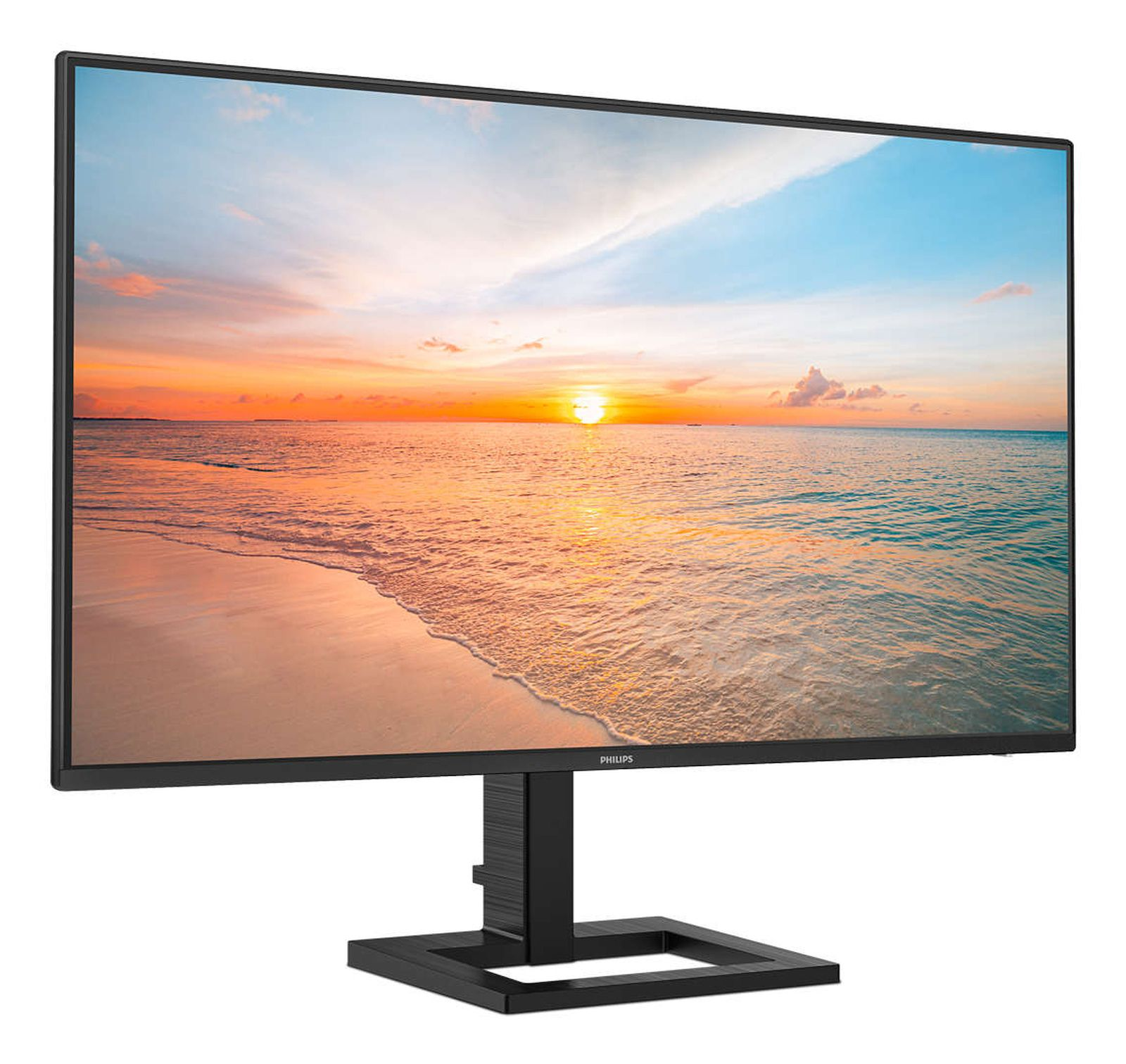 Een Philips monitor toont een serene strandzonsondergang met rustige golven en een kleurrijke lucht.