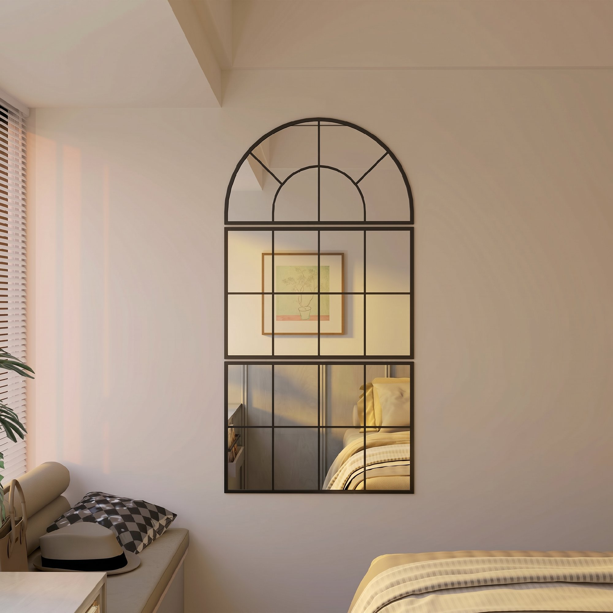 Un espejo de ventana arqueado con un cuadro y una cama reflejada.