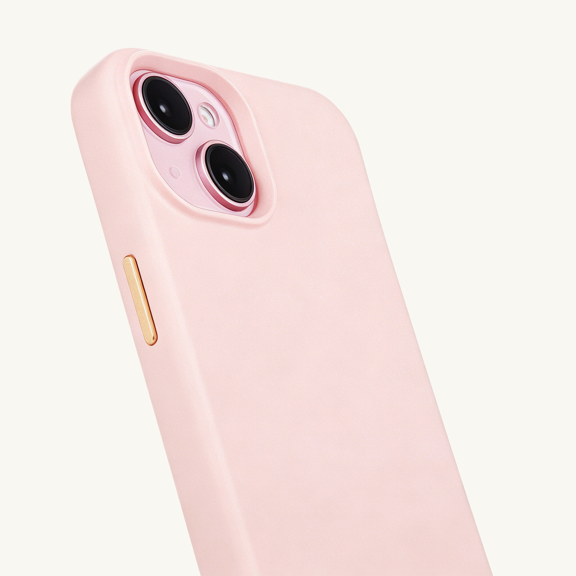 A close-up of a pink iPhone case showing the camera lenses and a gold button.