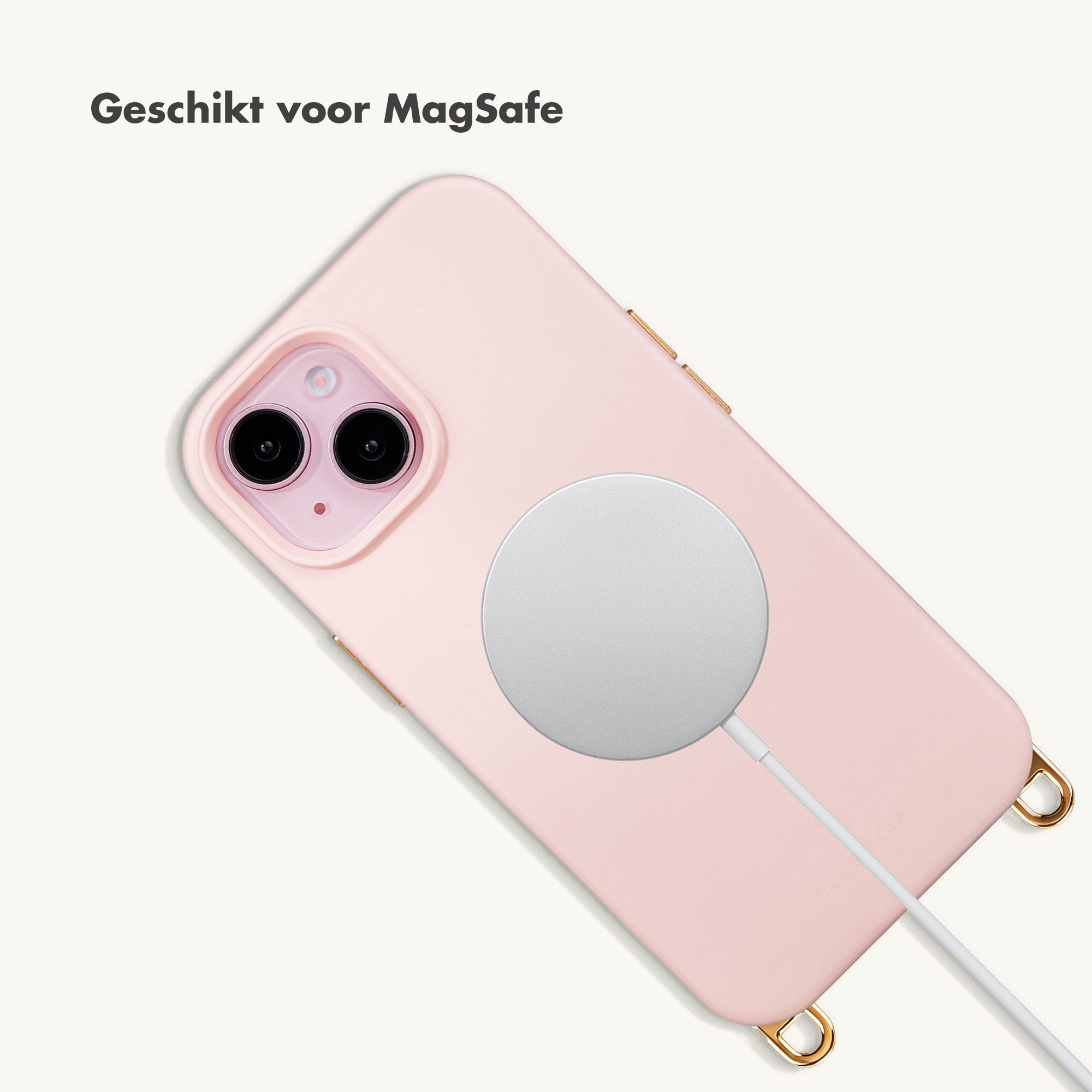 A pink iPhone with a MagSafe charger and cable.