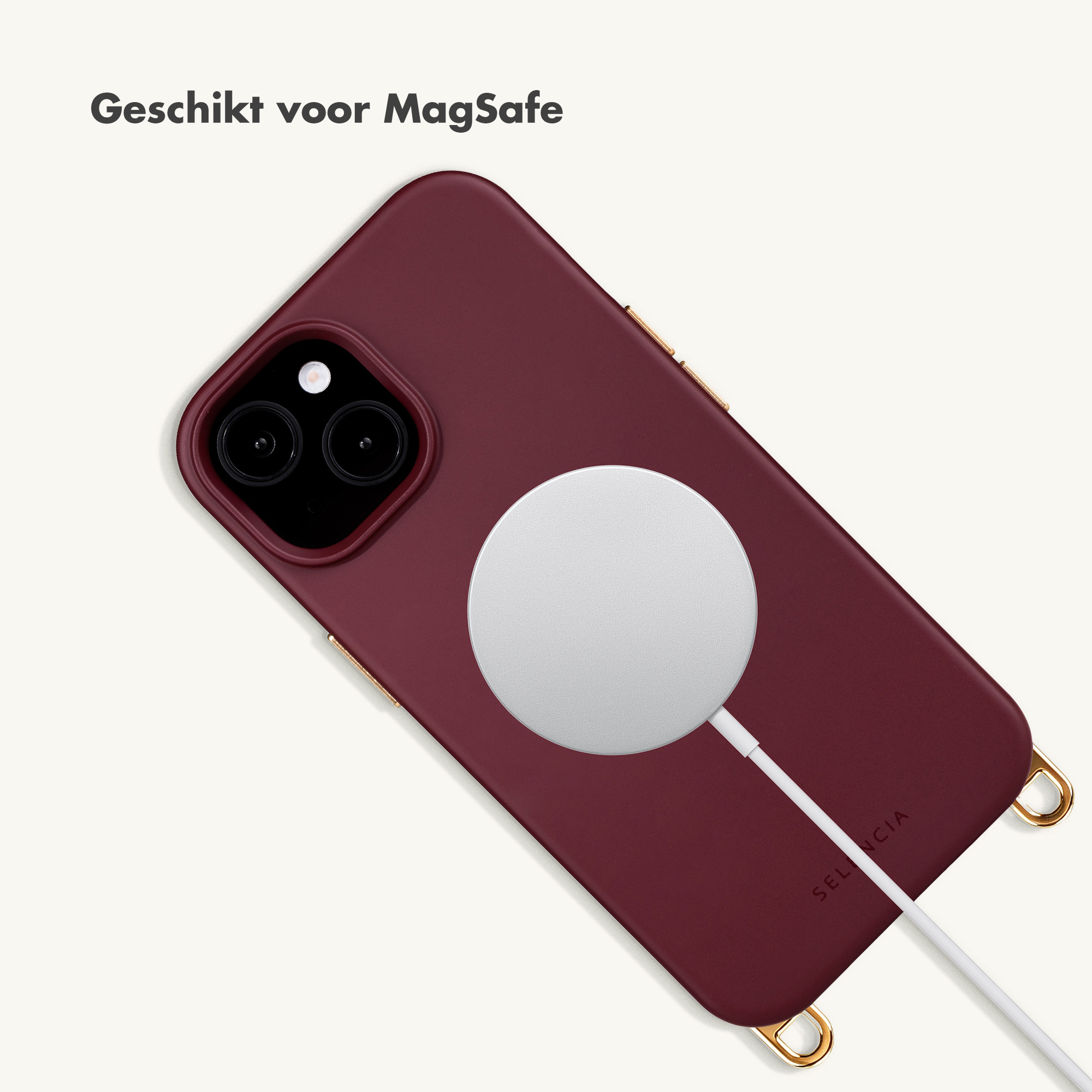 A dark red iPhone with a MagSafe charger and white cable on a light background.