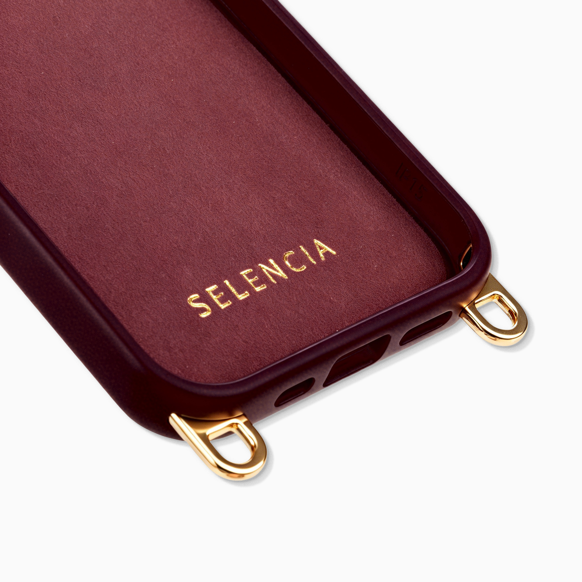 Dark red phone case with gold loops and embossed logo.