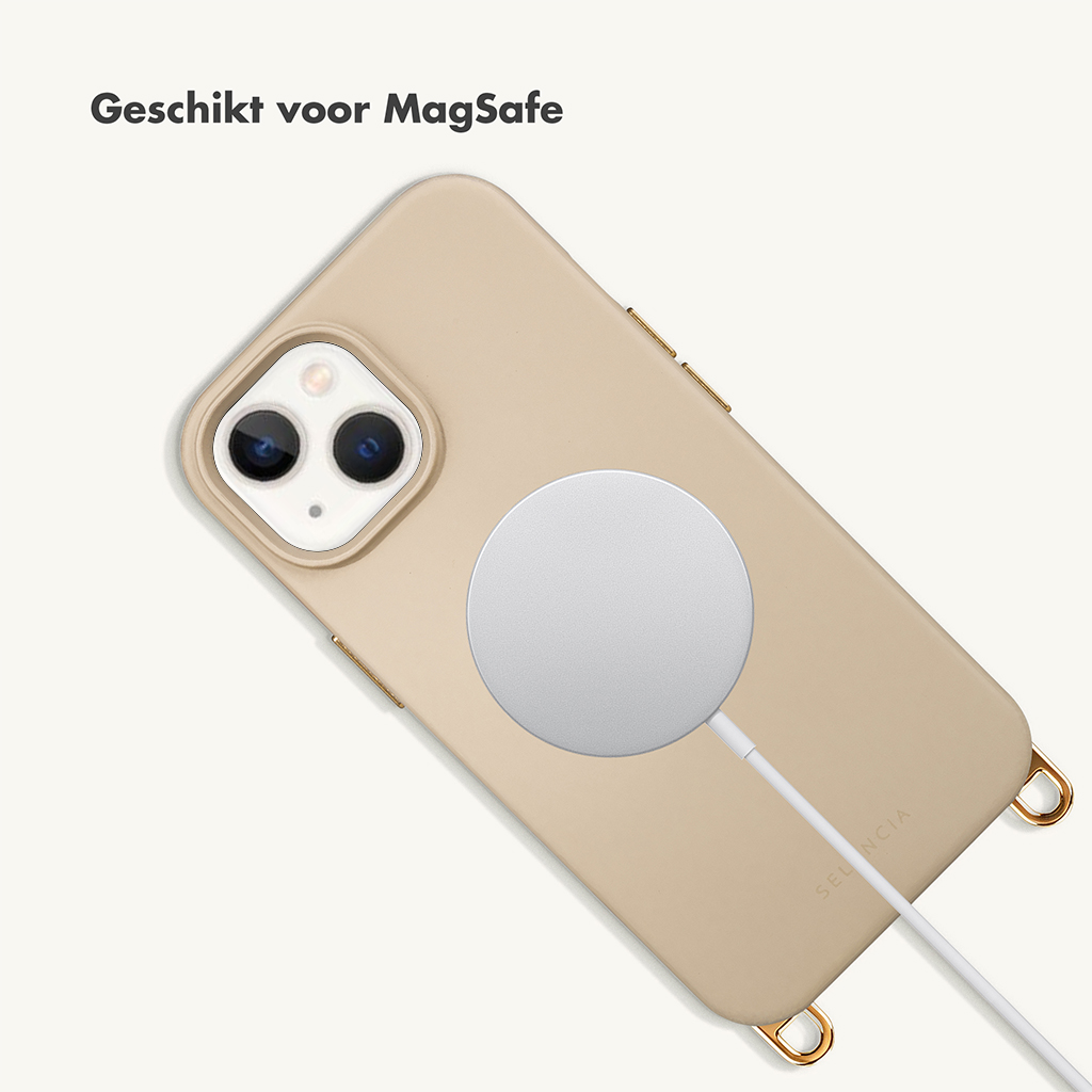 A beige iPhone with a MagSafe charger attached to the bottom.