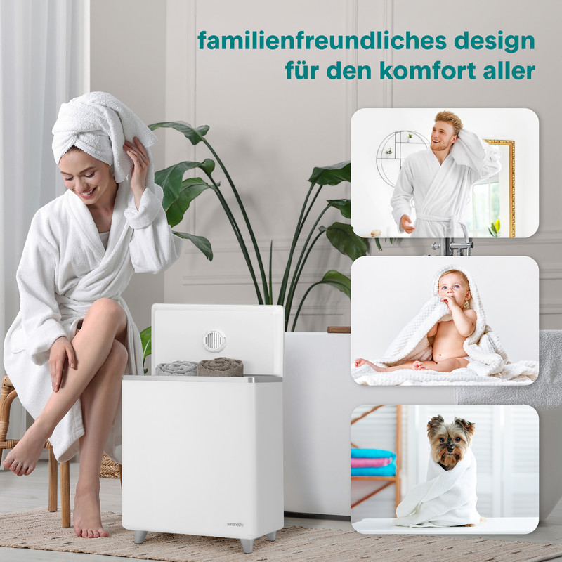 Frau, Baby, Mann und Hund in Handtüchern, neben einem weißen Handtuchwärmer.