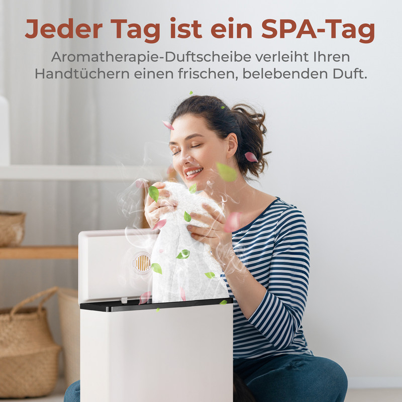 Eine Frau riecht an einem duftenden Handtuch über einem Diffusor.