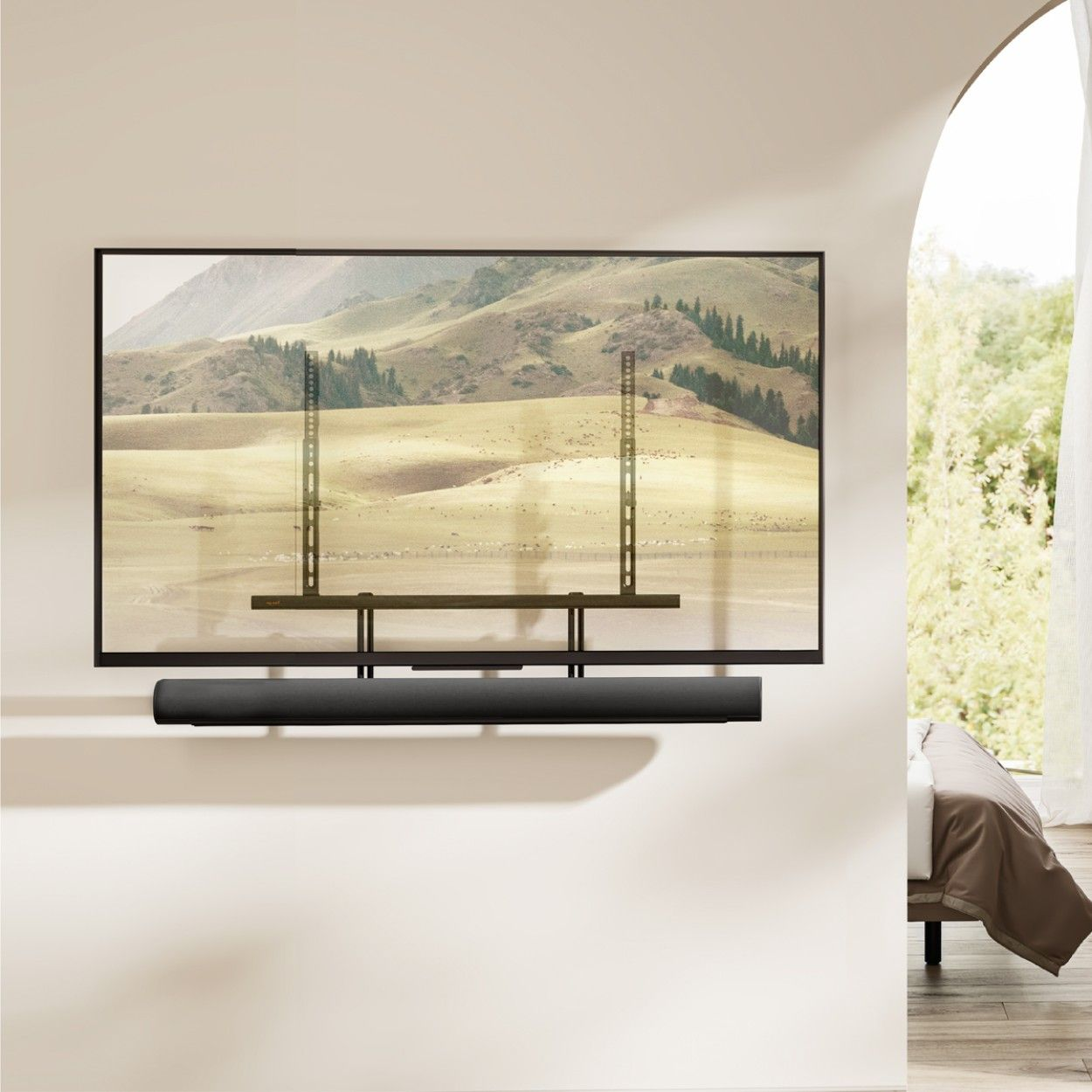 Ein schwarzer Soundbar unter einem Fernseher, der eine Landschaft zeigt.