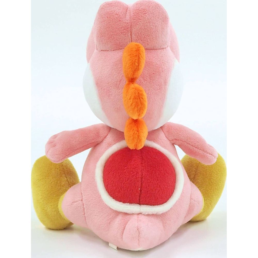Un peluche rosa di Yoshi con piedi gialli è seduto di spalle.