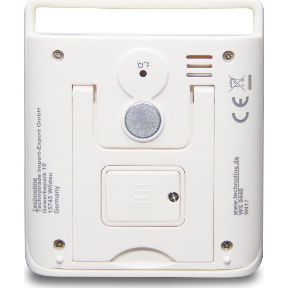 White device with text, battery compartment, magnet and temperature display.