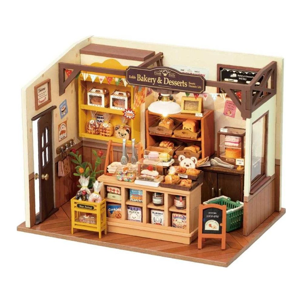 Panadería en miniatura con estantes llenos de pan, pasteles y galletas. Un letrero dice 'Bakery & Desserts'.