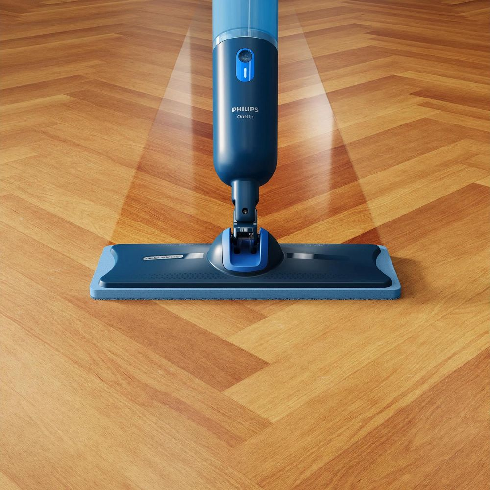 Un pulitore per pavimenti Philips OneUp blu lava un pavimento in legno.