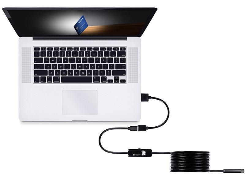 Laptop podłączony do endoskopu USB leżącego na stole.
