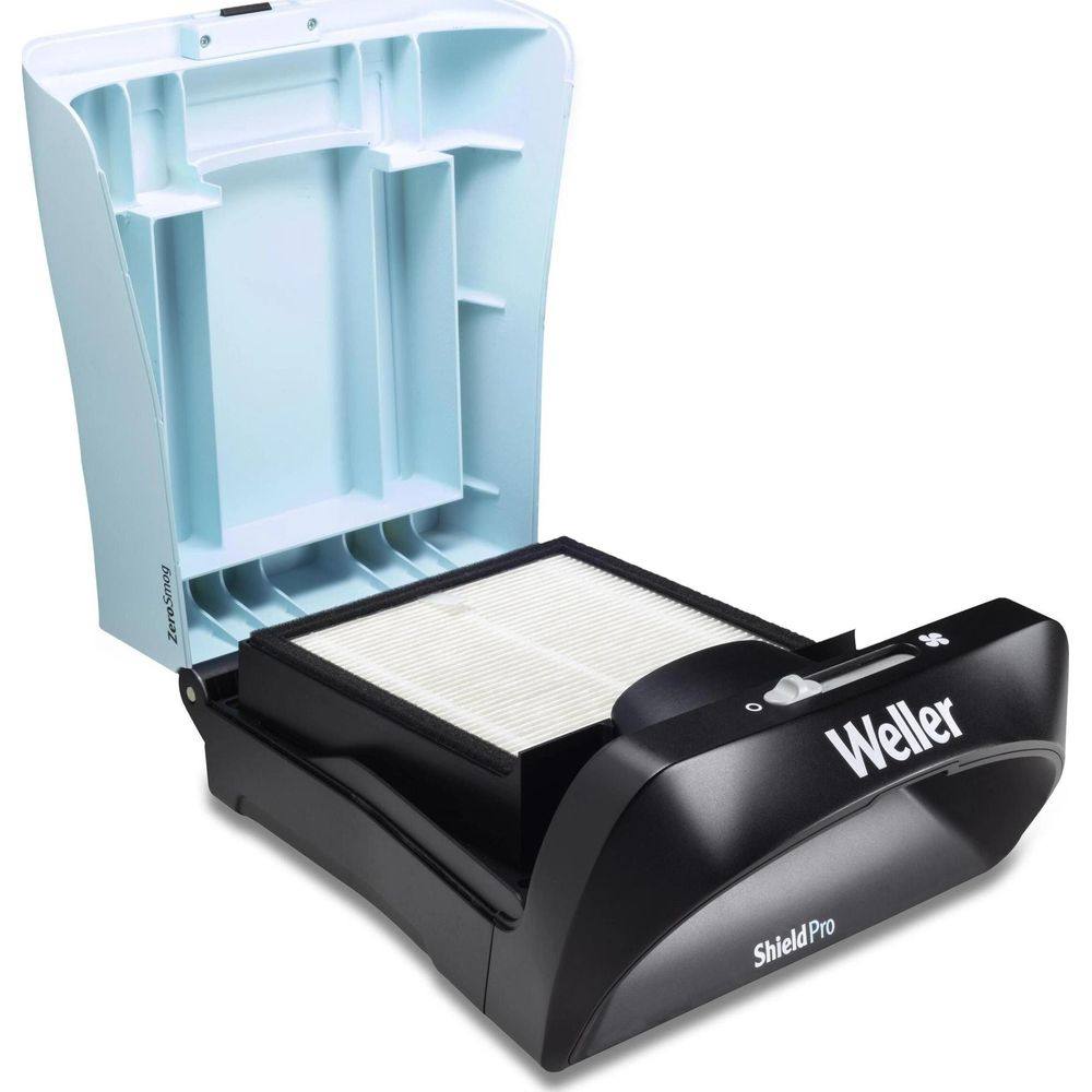 Un extracteur de fumée Weller Shield Pro noir avec son couvercle bleu clair ouvert, montrant un filtre blanc.