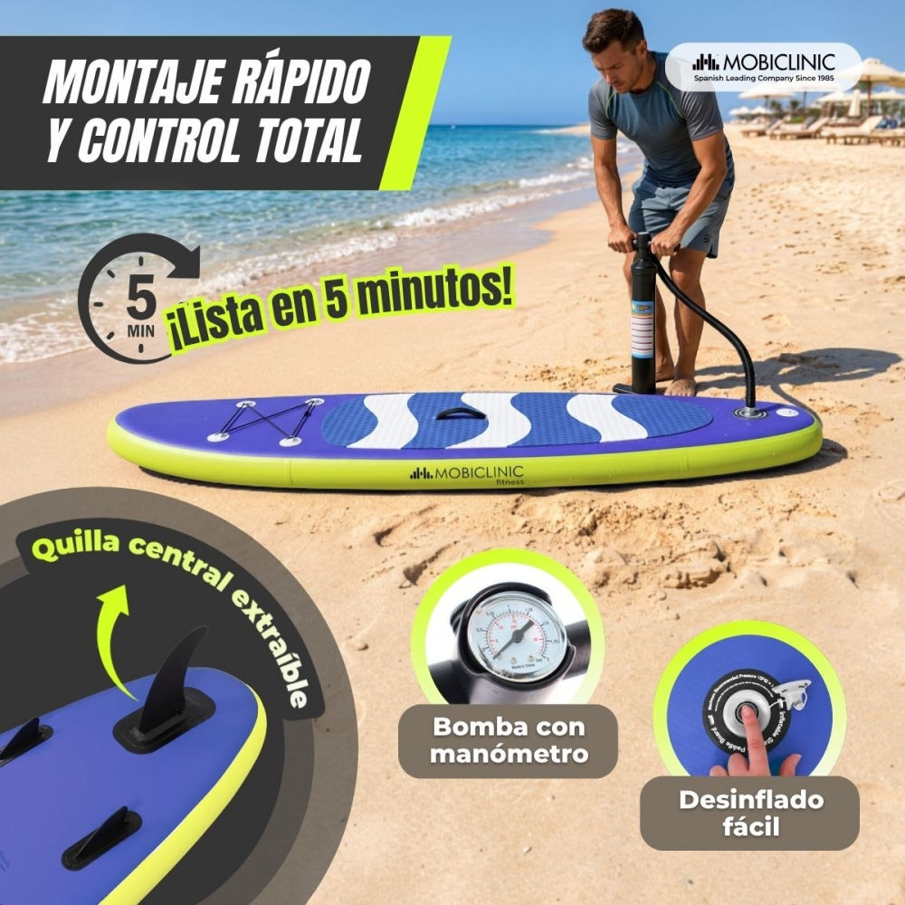 Hombre infla tabla SUP en playa. Se ven manómetro y quilla central.