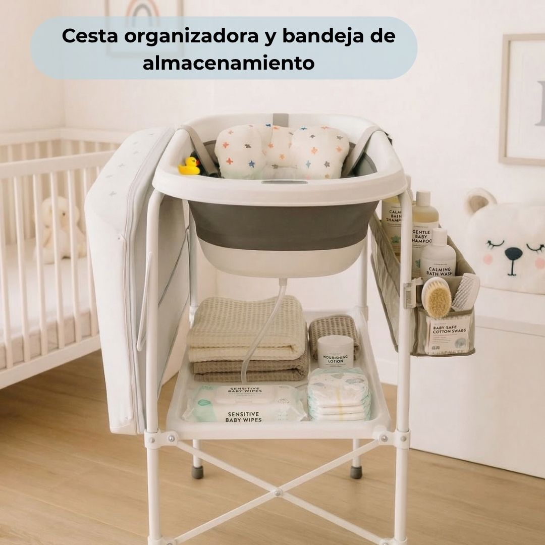 Estación de baño organizada para bebé con tina, toallas, pañales y artículos de tocador.